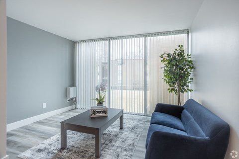 a living room with a blue couch and a coffee table