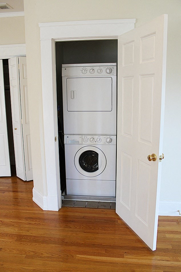 a small closet with a washing machine in it