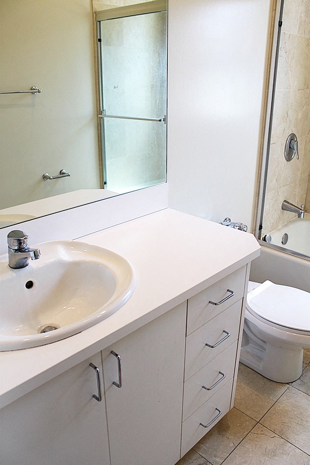 a bathroom with a sink and a toilet and a mirror