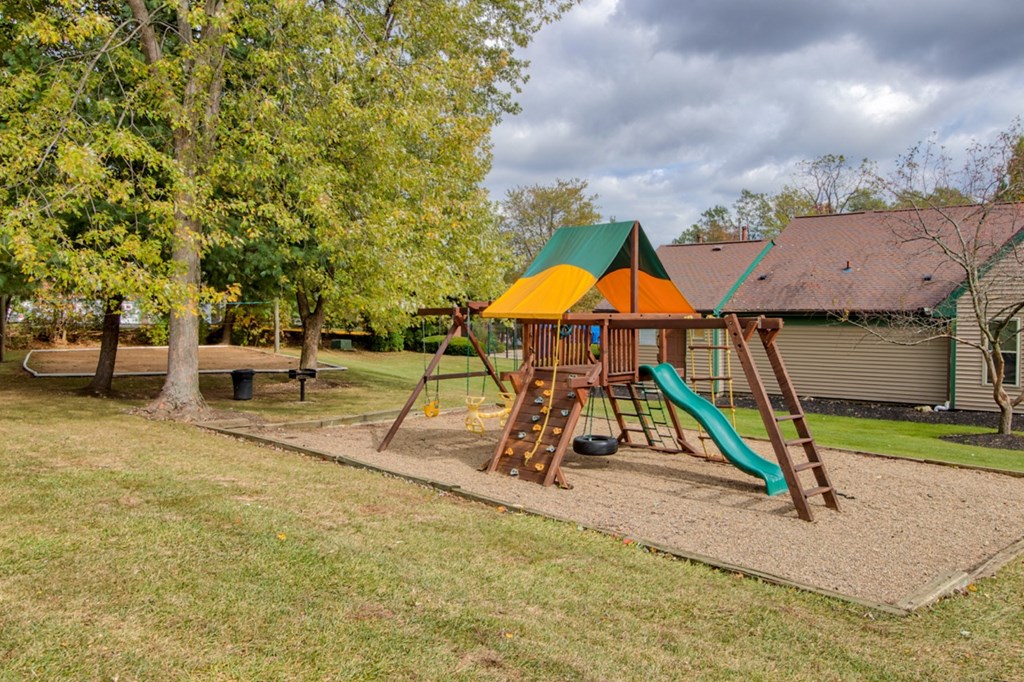 Playground in a park-like setting at Hunt Club Apartments, Integrity Realty, Copley, OH