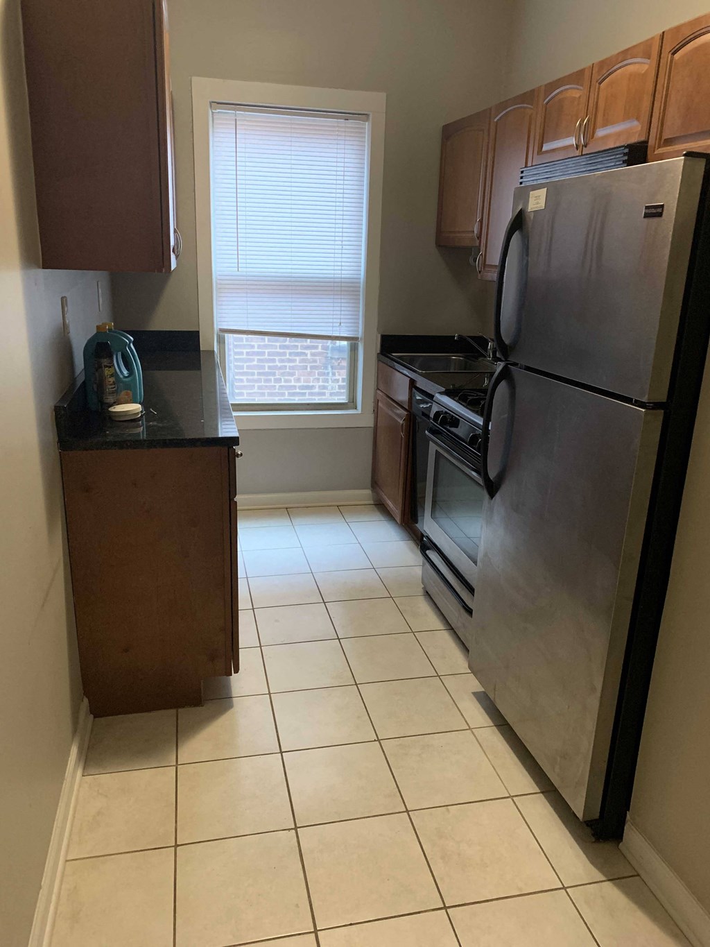 a kitchen with stainless steel appliances and a window