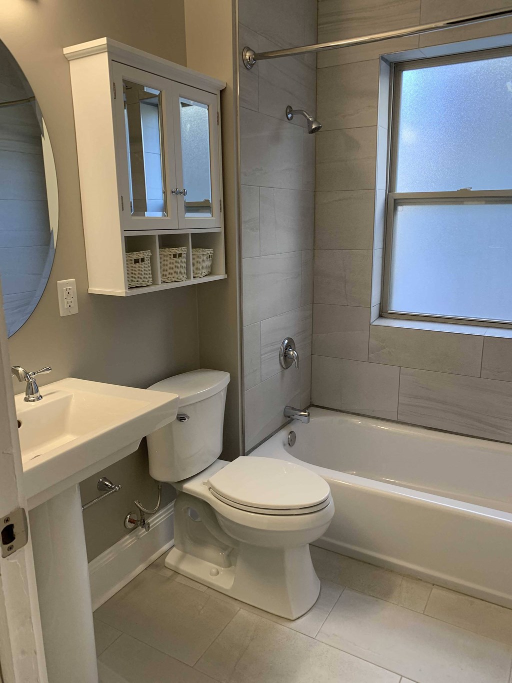 a bathroom with a toilet and a tub and a sink