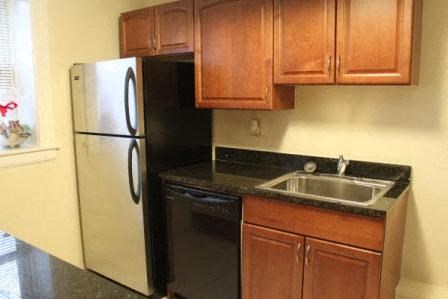a kitchen with a sink and a refrigerator