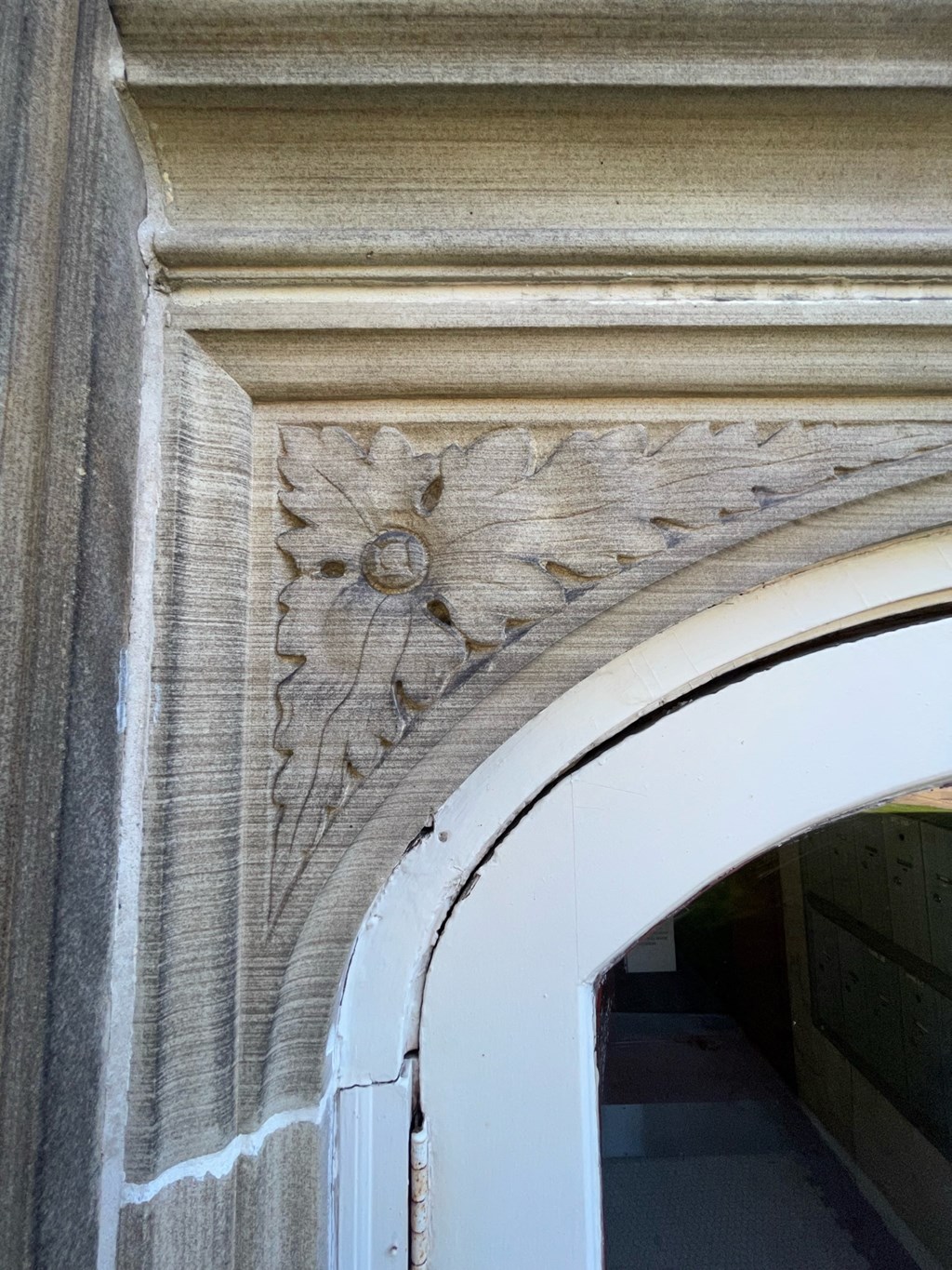 an ornate archway with a white door in a building