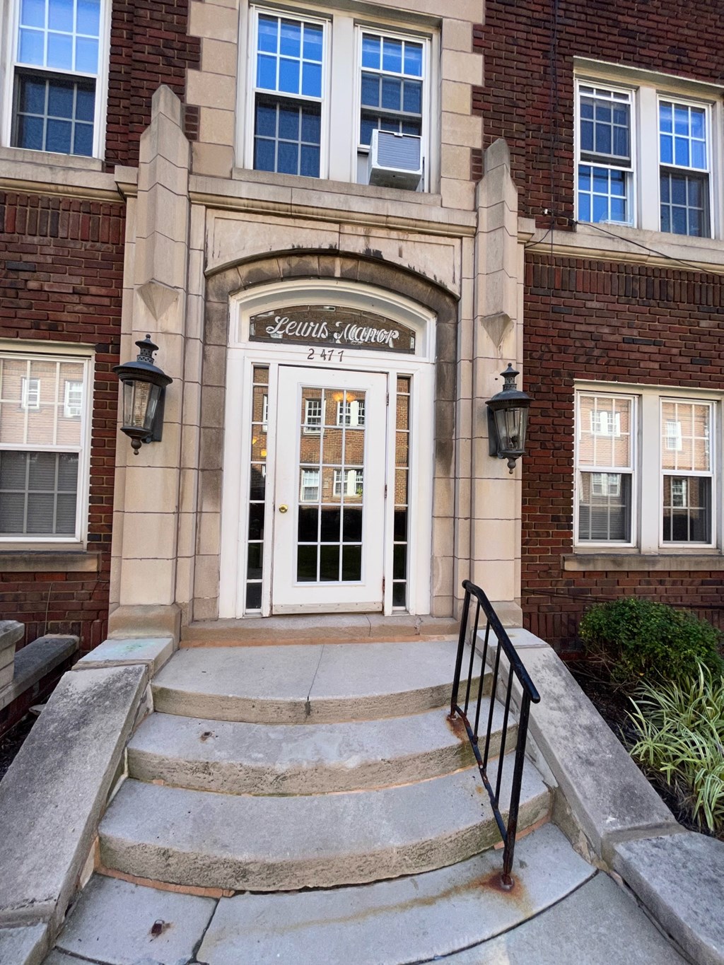 the front door of a building with stairs in front of it