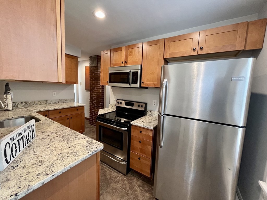 a kitchen with stainless steel appliances and granite counter tops