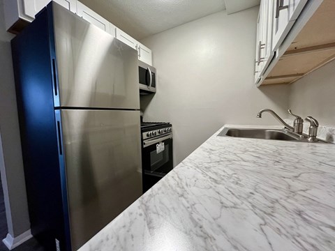 a kitchen with stainless steel appliances and a new counter top