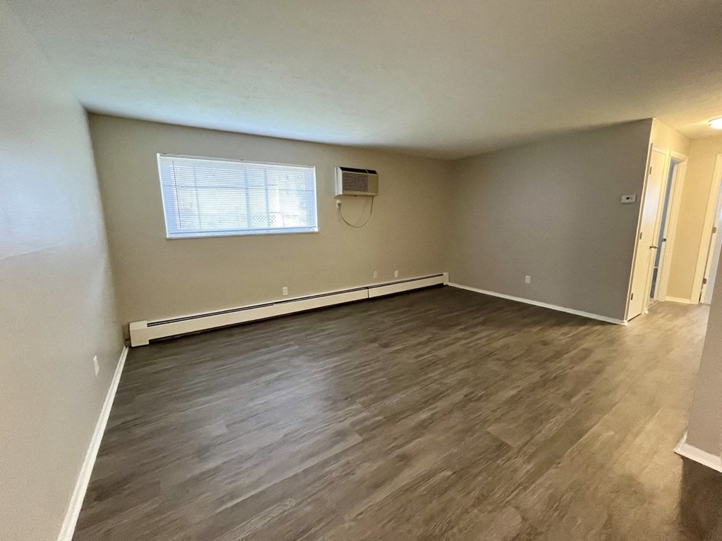 living room with plank style floors and a window