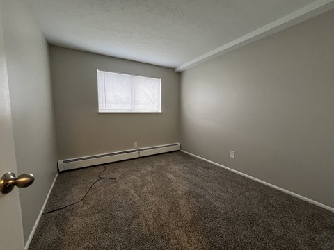 Bedroom 2 with carpet and a window