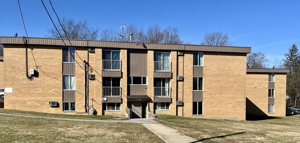 an image of a brick apartment building with balconies