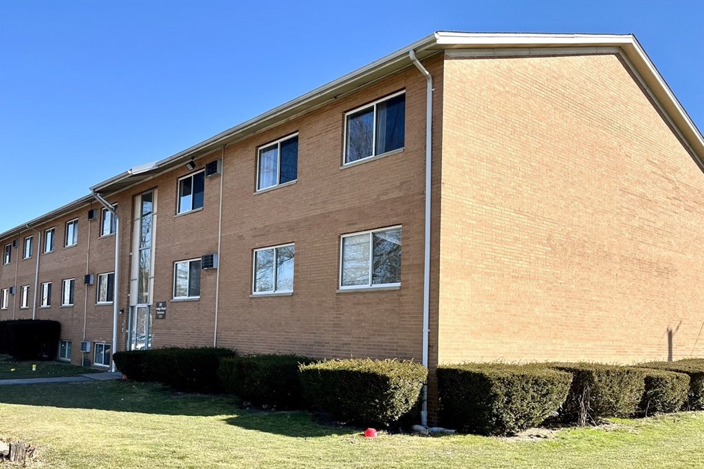 a large brick building with a blue sky in the background