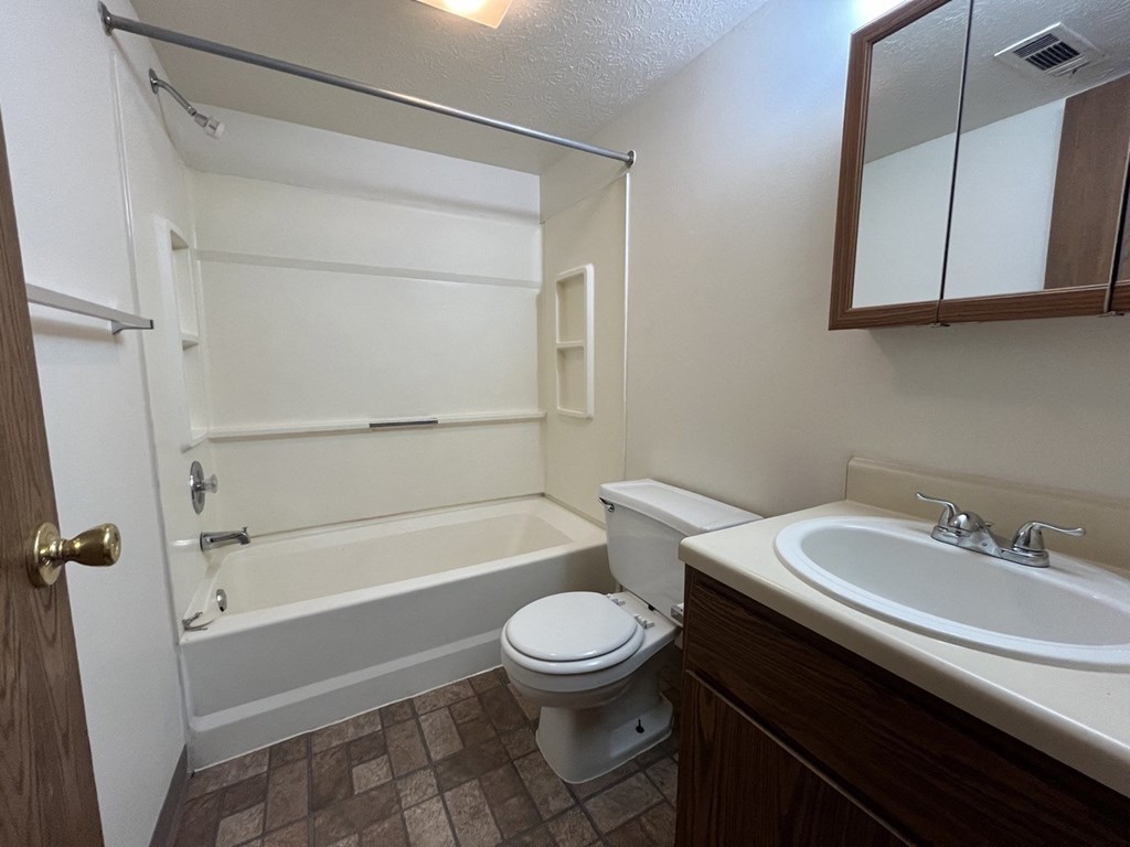 the preserve at ballantyne commons apartment bathroom with tub sink and toilet
