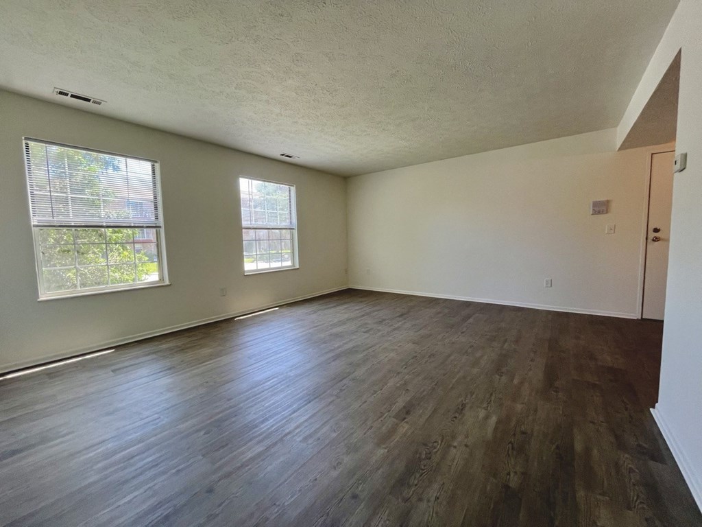 the living room of an apartment with plank style flooring at Renova of Brunswick, Ohio, 44212