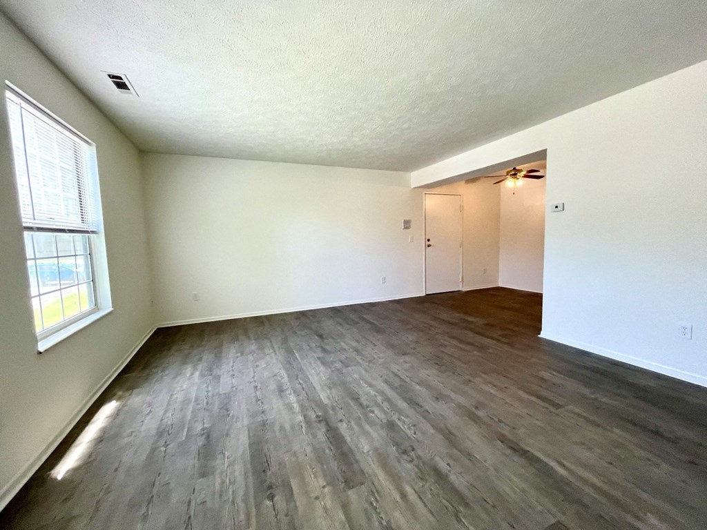 an empty living room with wood floors and white walls at Renova of Brunswick, Brunswick, OH 