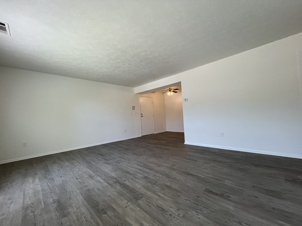 the living room of an apartment with wood floors and white walls at Renova of Brunswick, Brunswick Ohio 
