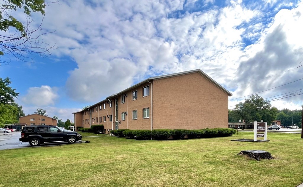 a large brick building with a car parked in front of it