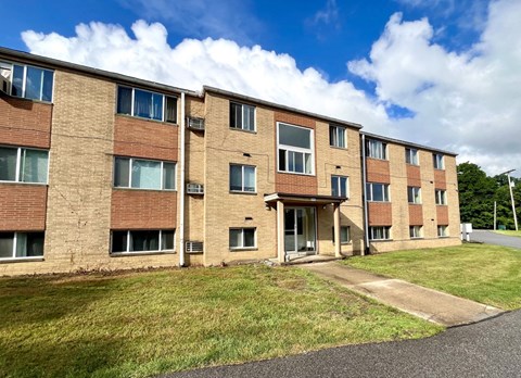 an image of a brick apartment building on a sunny day