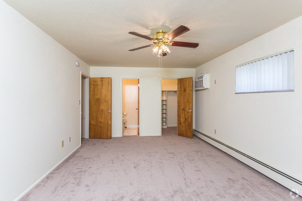 a empty living room with a ceiling fan