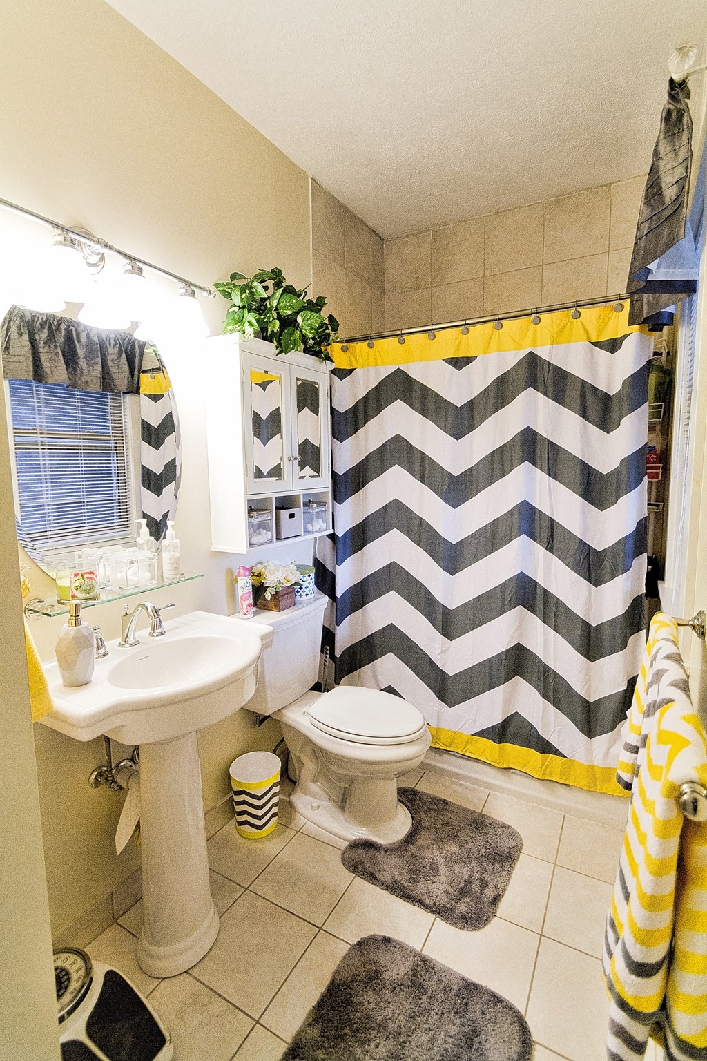a bathroom with a black and white shower curtain and a sink