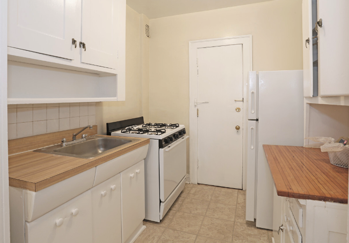 a kitchen with white appliances and a sink and a refrigerator