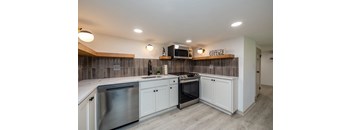 a kitchen with stainless steel appliances and white cabinets