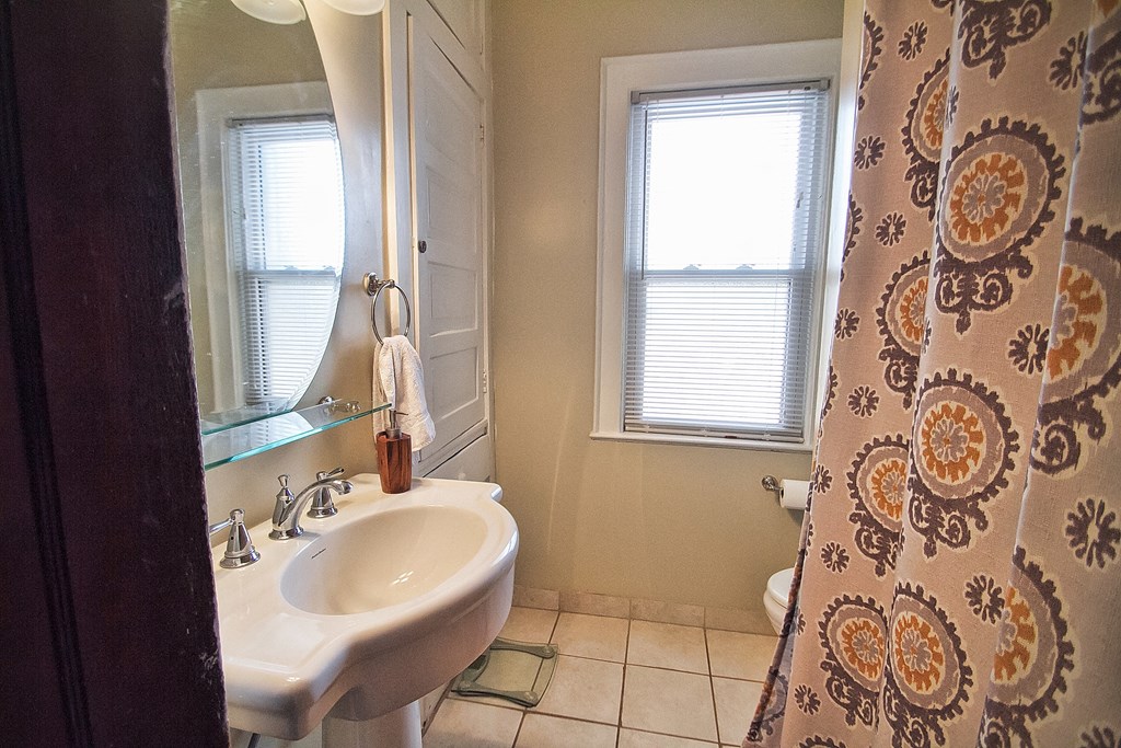 a bathroom with a sink and a shower curtain