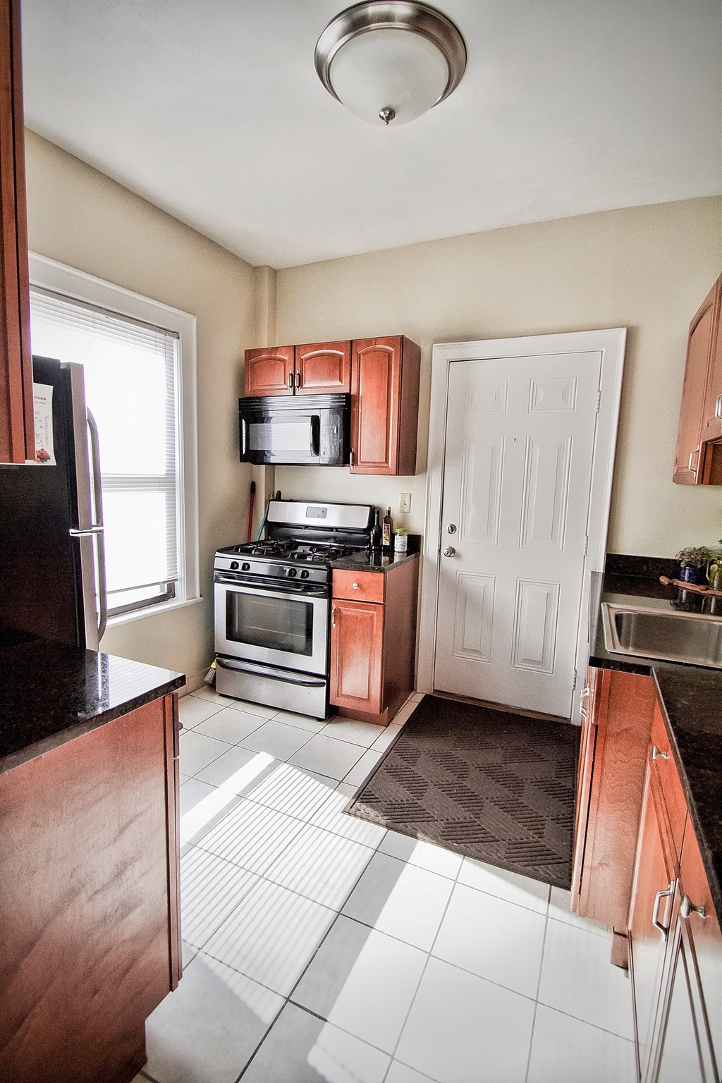 a kitchen with wooden cabinets and stainless steel appliances