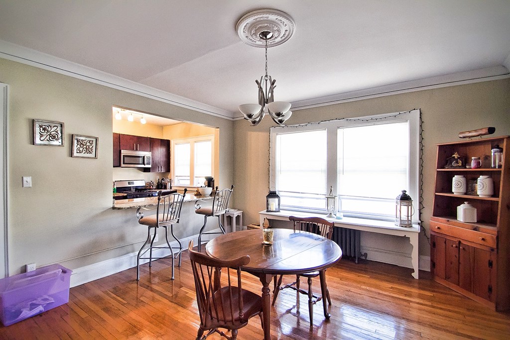 a living room with a dining room table and a kitchen