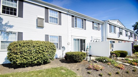 a white house with a yard in front of it