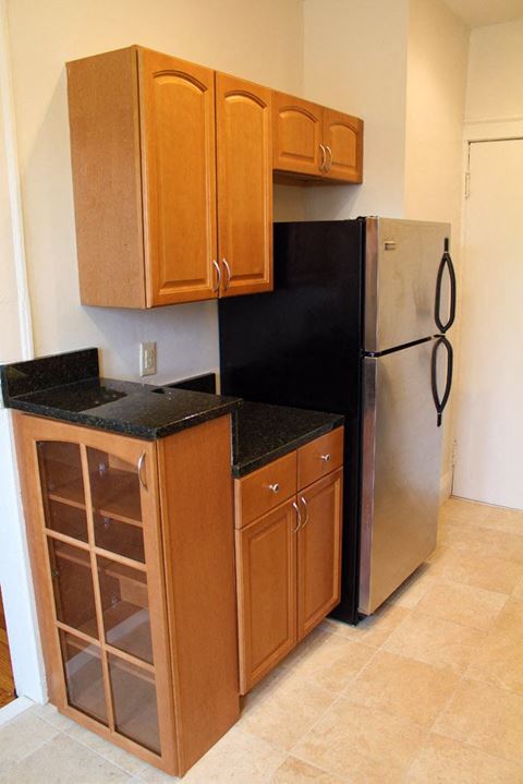 a small kitchen with a refrigerator and cabinets