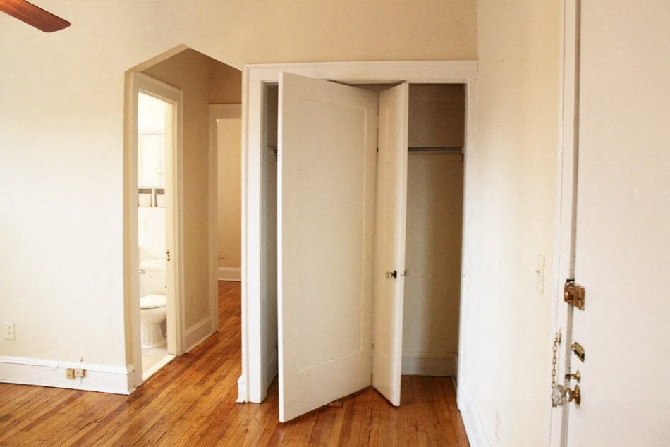 an empty room with three closet doors in it