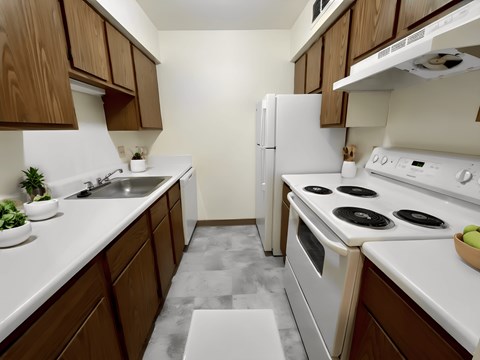 a kitchen with white appliances and wooden cabinets