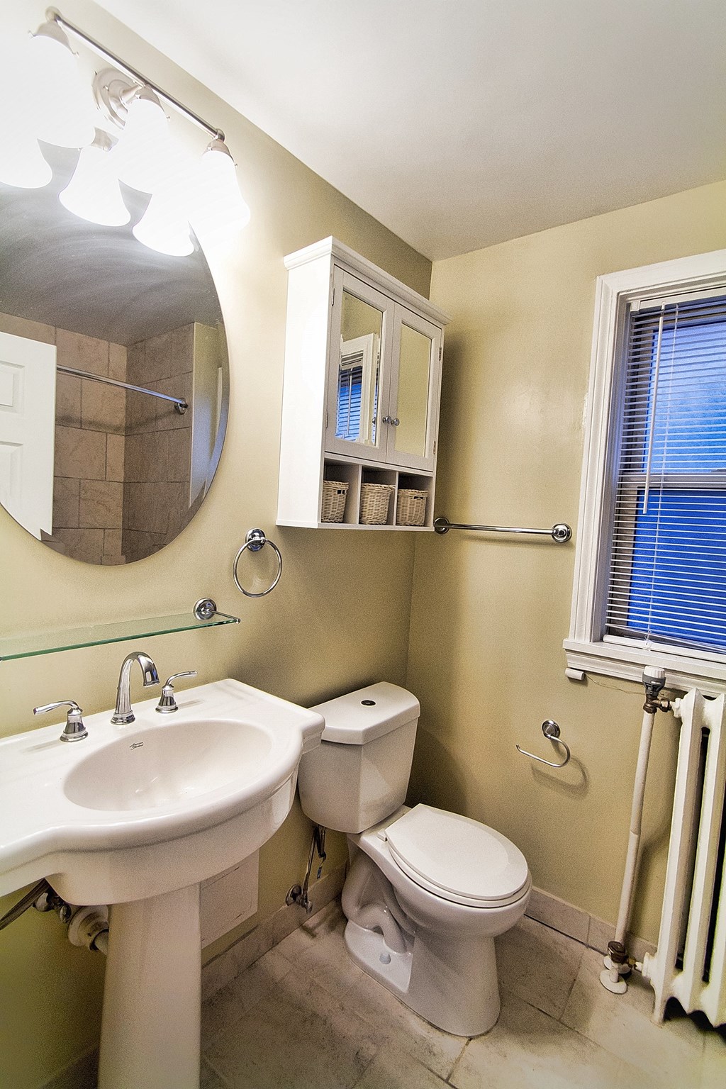 a bathroom with a sink toilet and a mirror