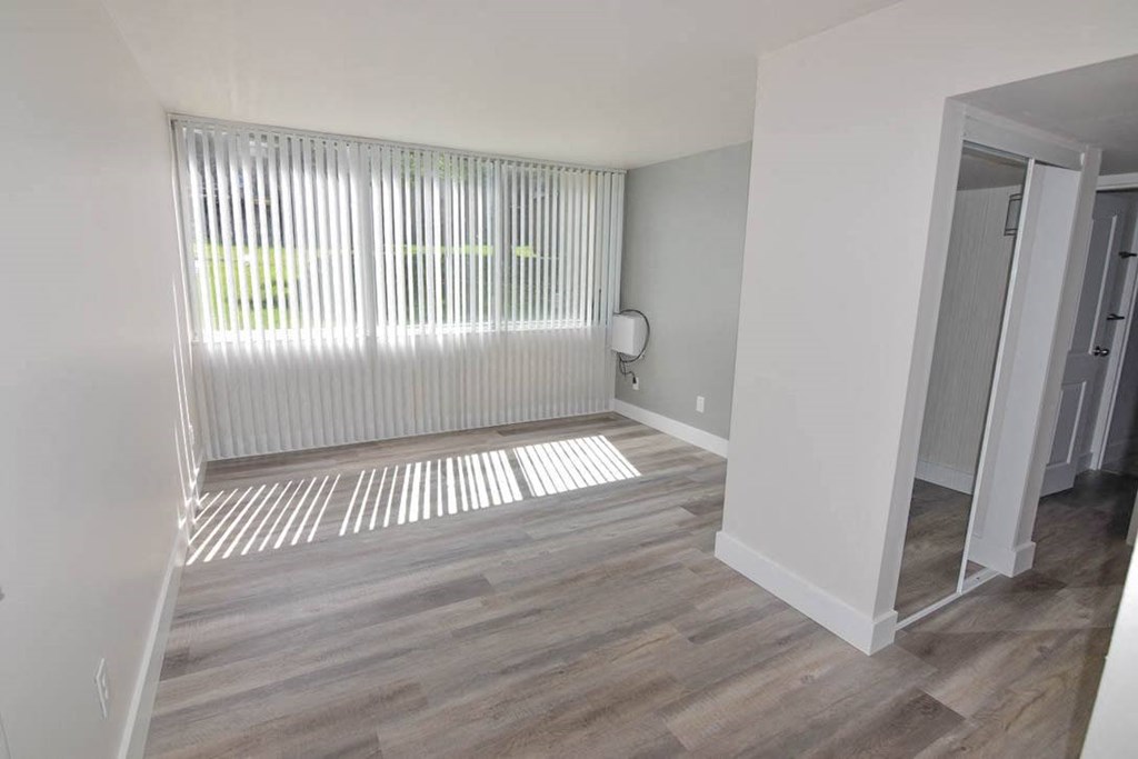 Spacious living room with large windows at Eagles Landing Apartments, Integrity Realty, Ohio, 44240