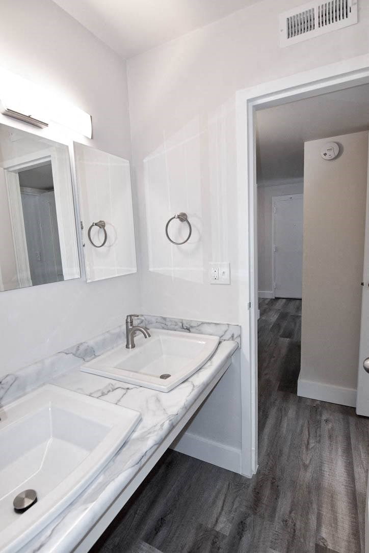 A renovated bathroom with two sinks at Eagles Landing Apartments, Integrity Realty, Kent