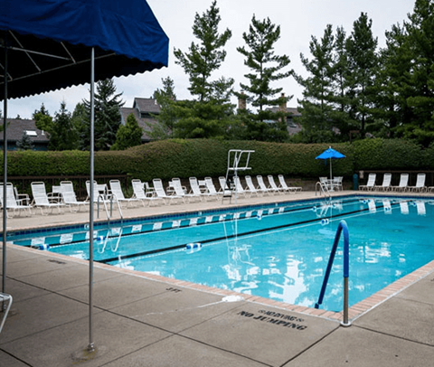 Outdoor swimming pool with lap lanes and lounge chairs at Atrium in The Village Apartments, Beachwood, 44122