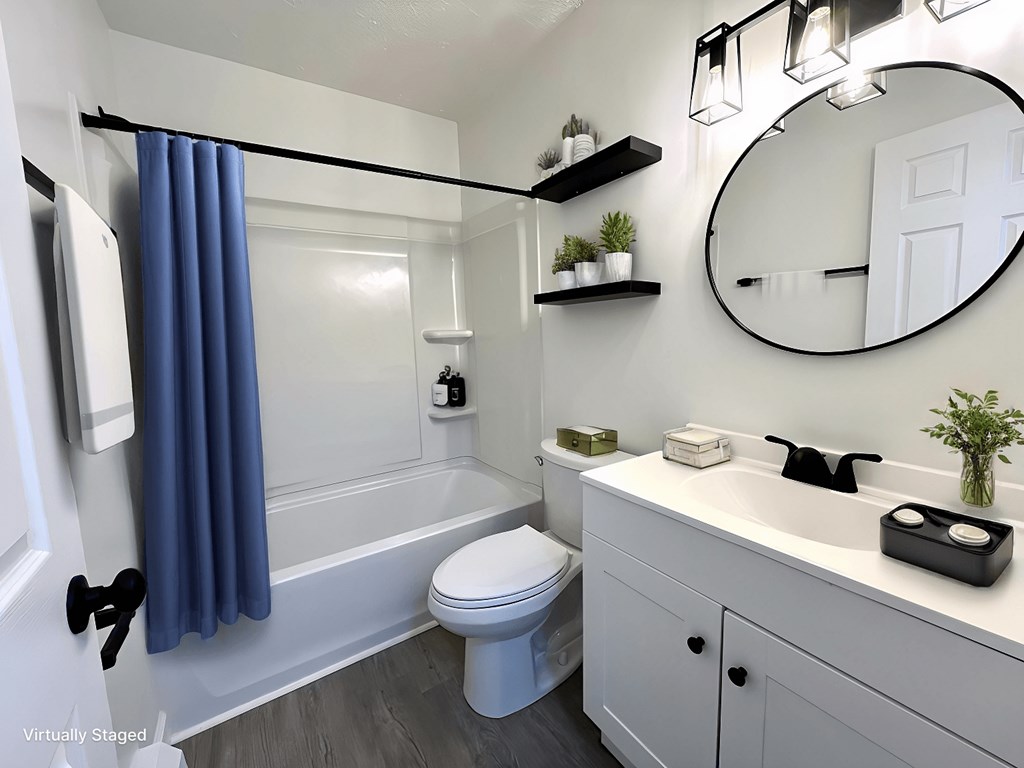 a bathroom with a white toilet and a tub and a sink at Renova of Brunswick, Ohio, 44212
