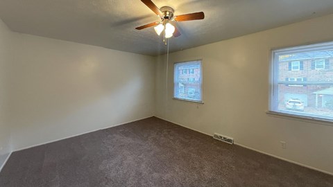 Large bedrooms with ceiling fans at Woodland Pointe Apartments and Townhomes, Integrity Realty, 44240