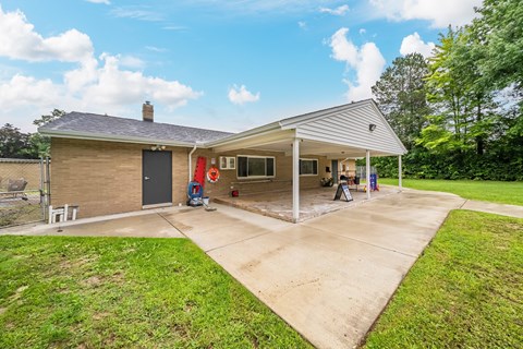 A house with a covered patio and a garage door.