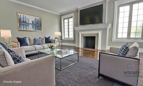 A living room with a fireplace and a television.
