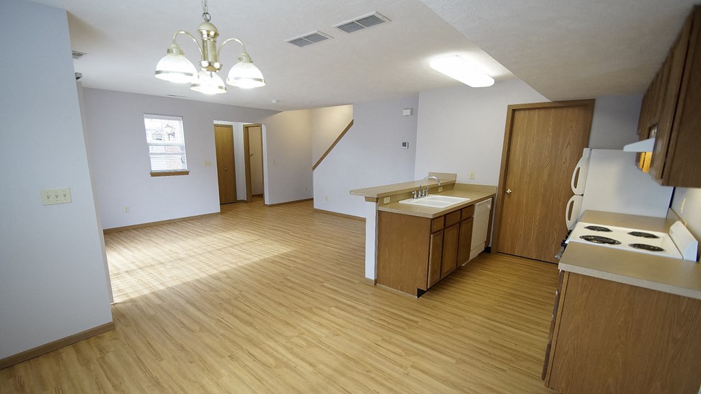an empty kitchen and living room in an empty house