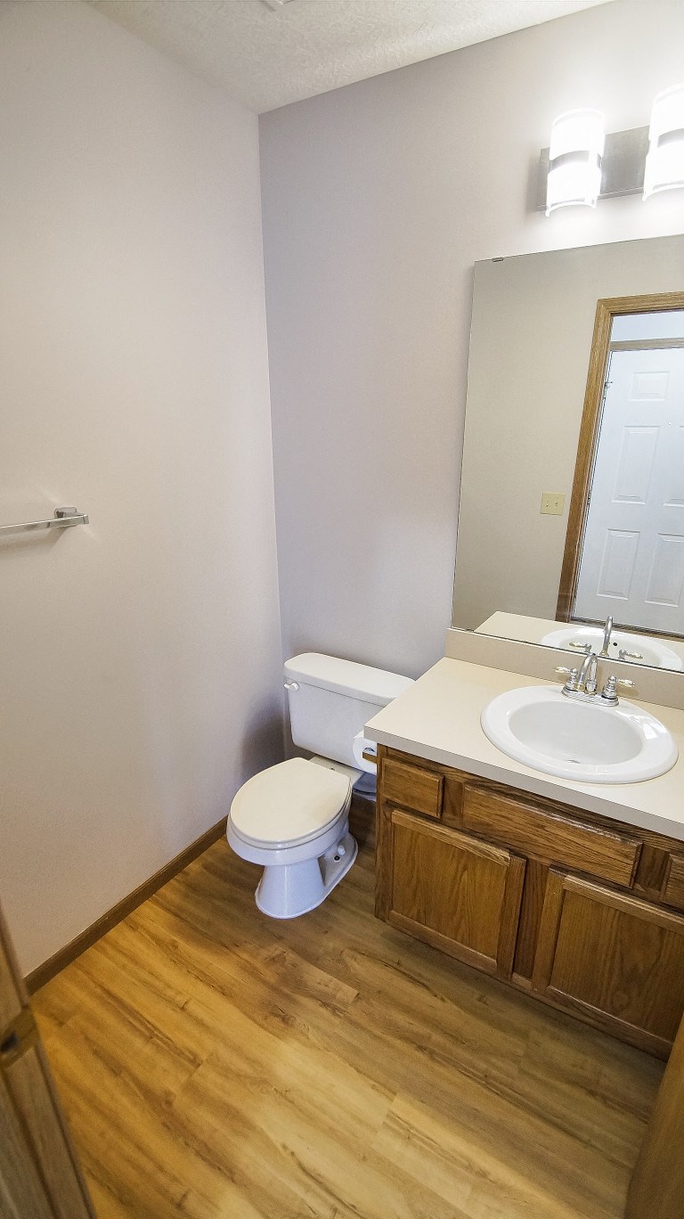 a small bathroom with a toilet sink and mirror
