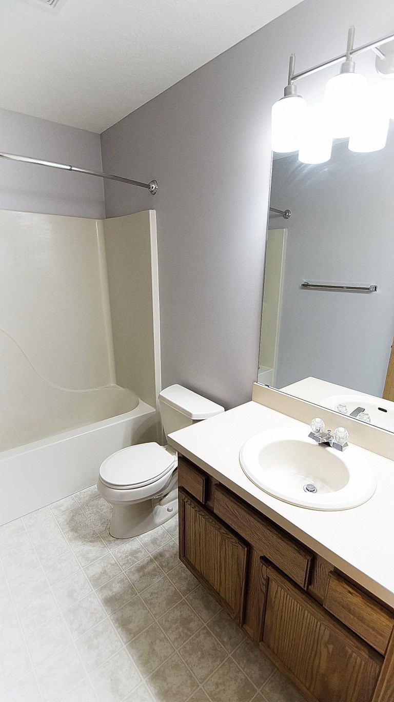 a bathroom with a sink toilet and a bath tub