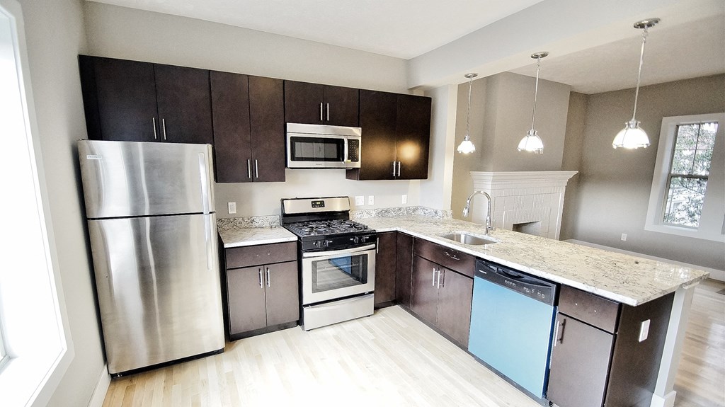 a kitchen with stainless steel appliances and marble counter tops