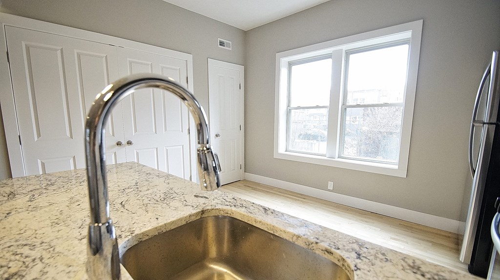 an empty kitchen with a sink and a window