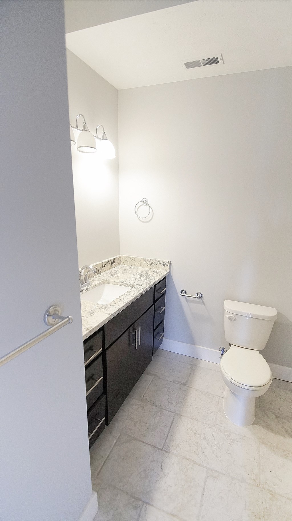 an empty bathroom with a toilet and a sink