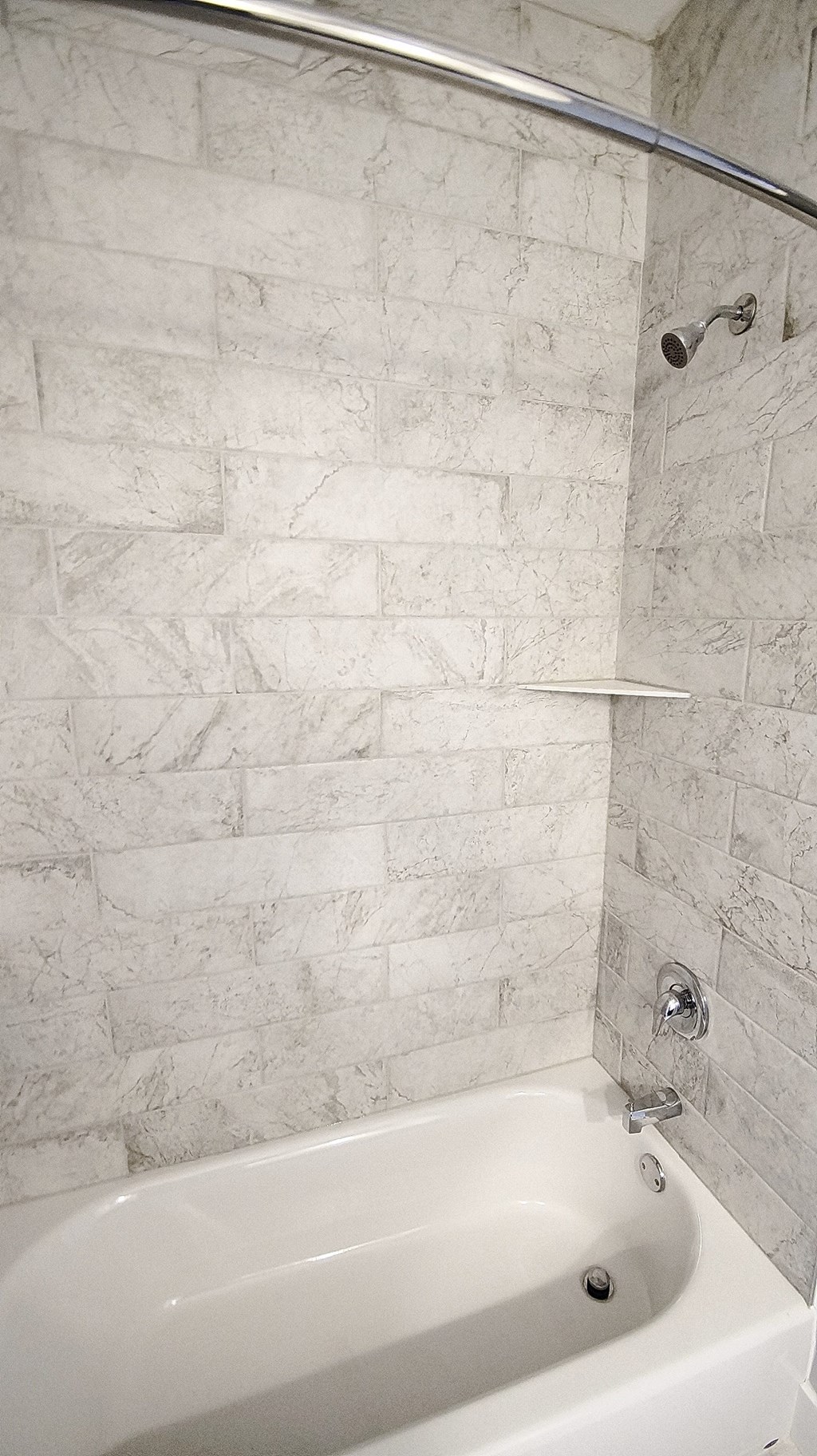 a bathroom with a shower and a bath tub