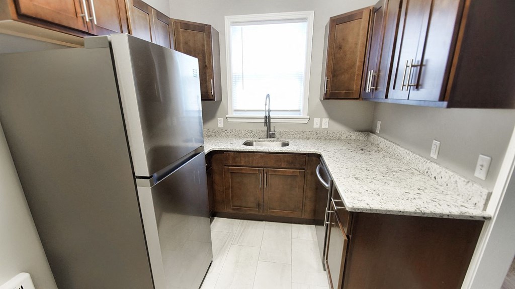 a kitchen with stainless steel appliances and marble counter tops