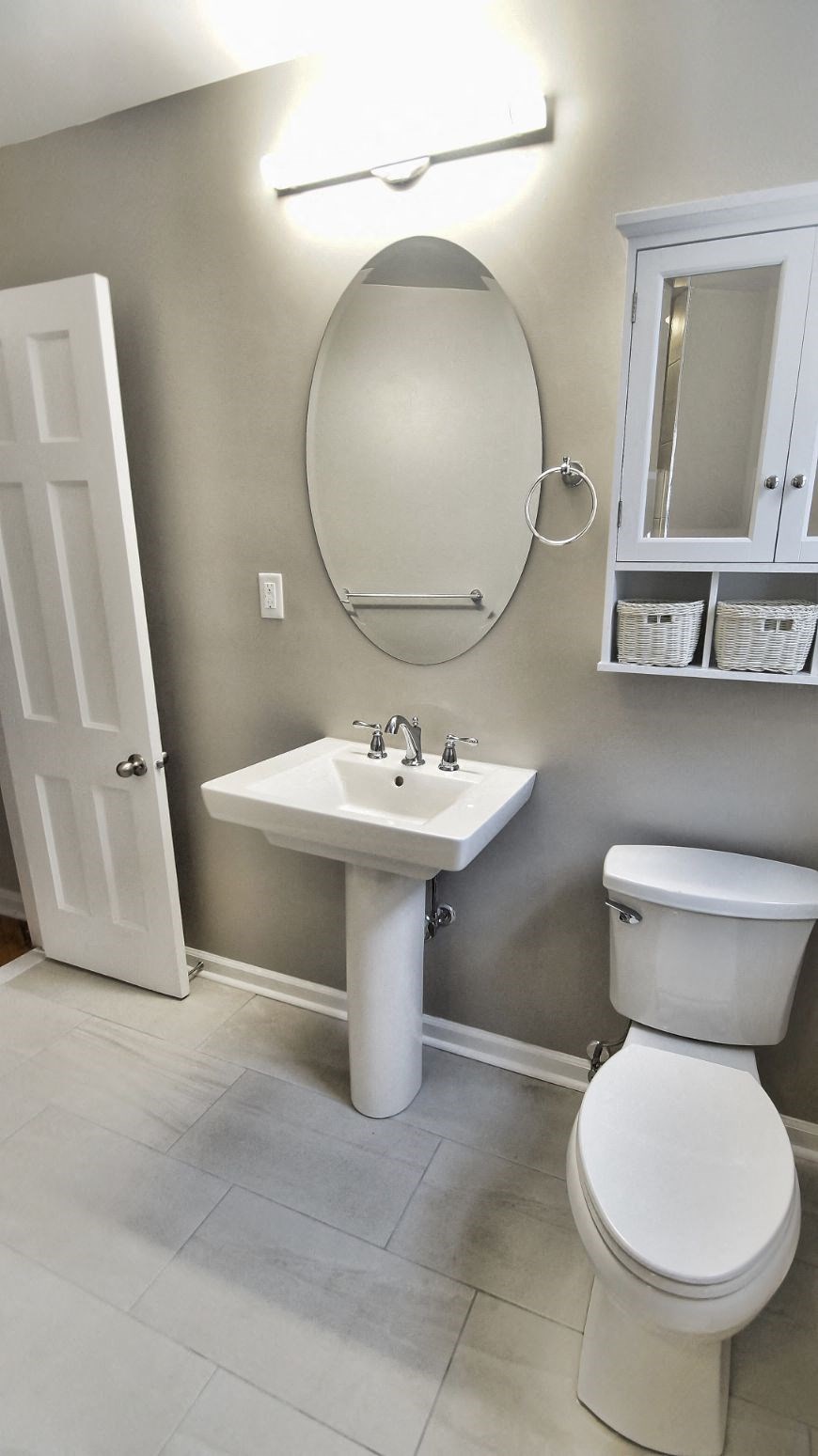 a bathroom with a sink toilet and a mirror