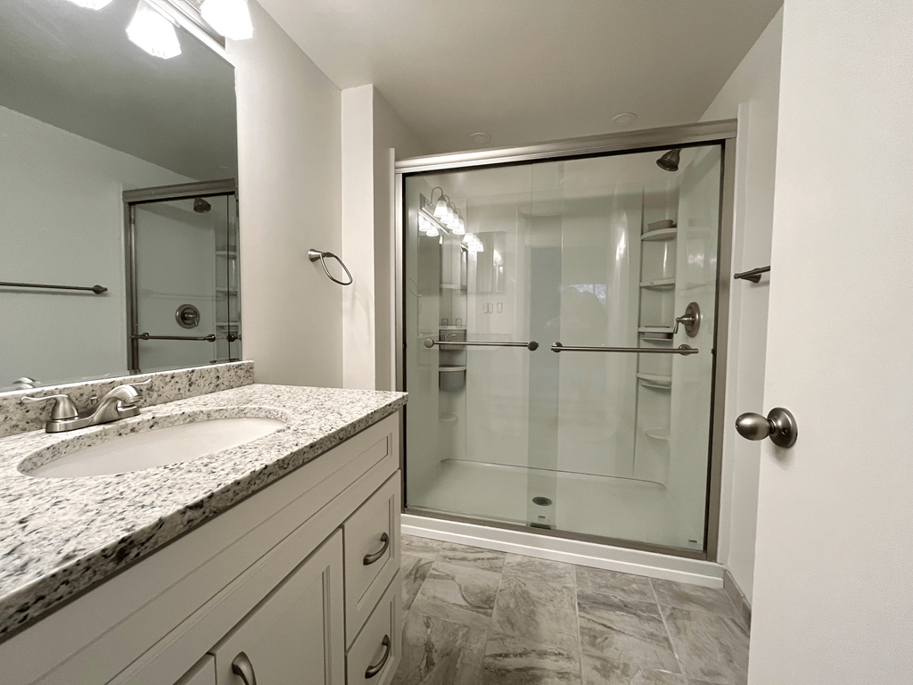 Updated bathroom with glass shower at Atrium in The Village, Beachwood Ohio
